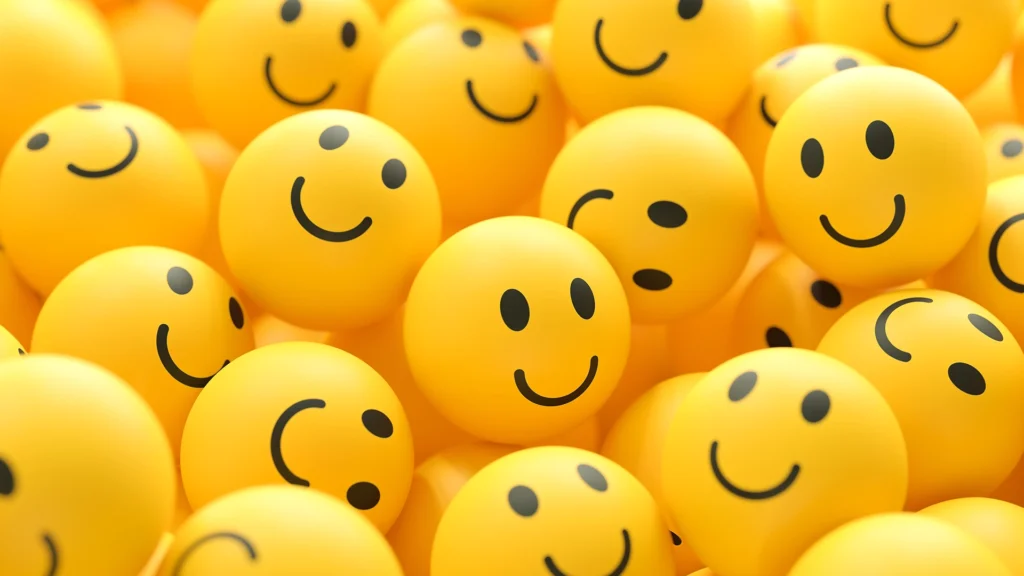 A sea of bright yellow balls with smiley faces